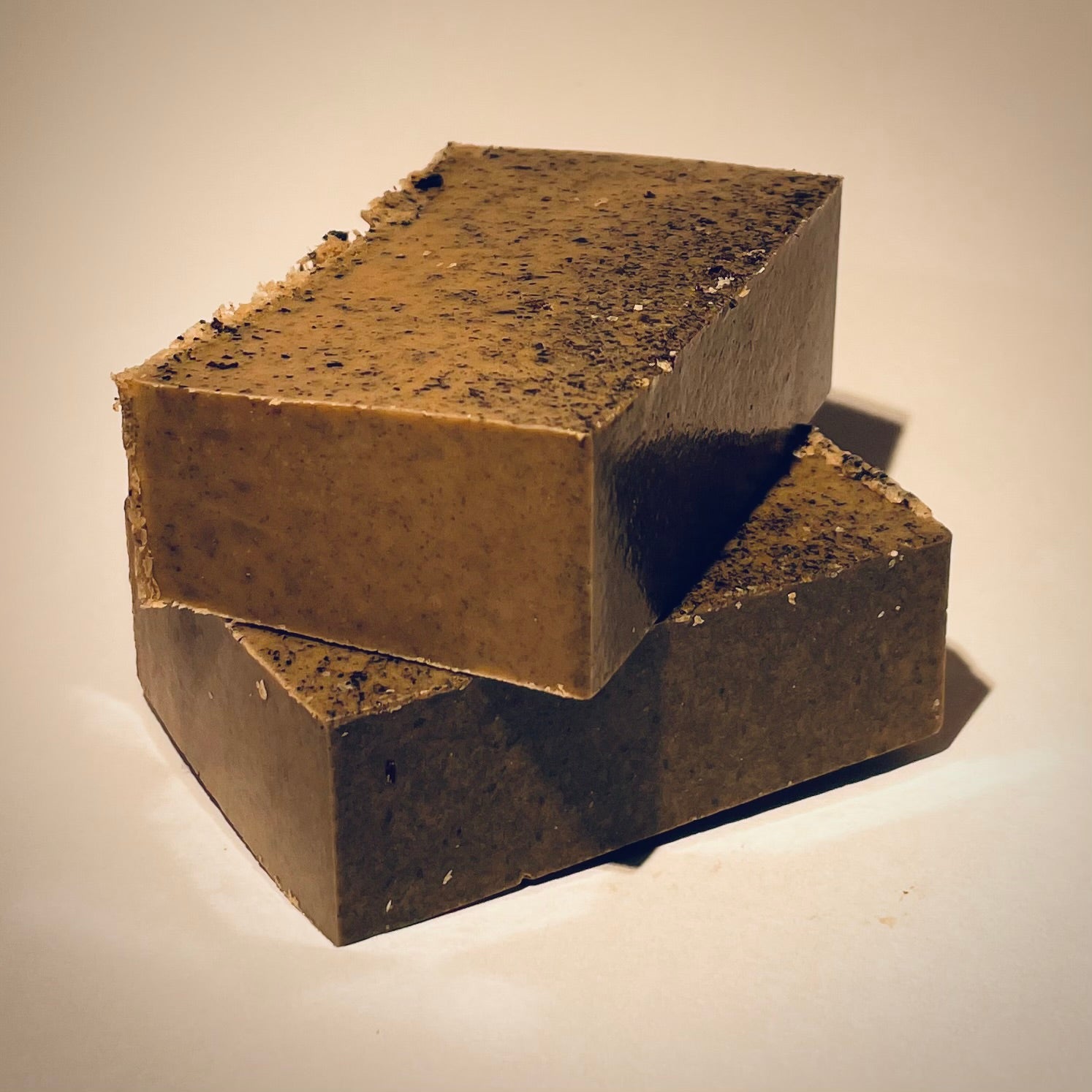 Sprüt brand soap bars stacked showing textural specks on a neutral background